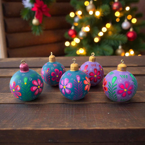 Hand-painted multicolor wooden Christmas ornaments with floral design, handmade in Oaxaca, Mexico
