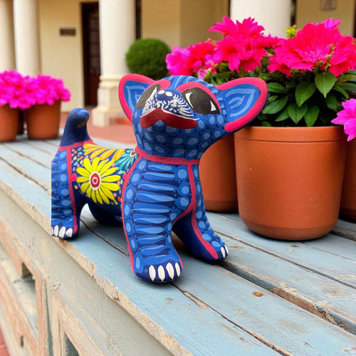 Handmade clay dog alebrije with traditional Mexican folk art painting