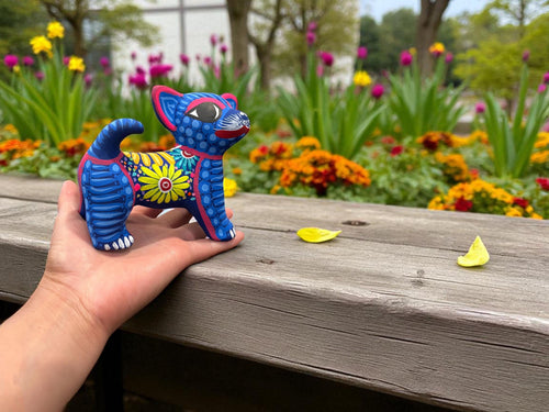 Hand-painted dog alebrije held in hand, handmade in Guanajuato Mexico