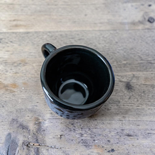 Black stoneware espresso cup with espresso shot