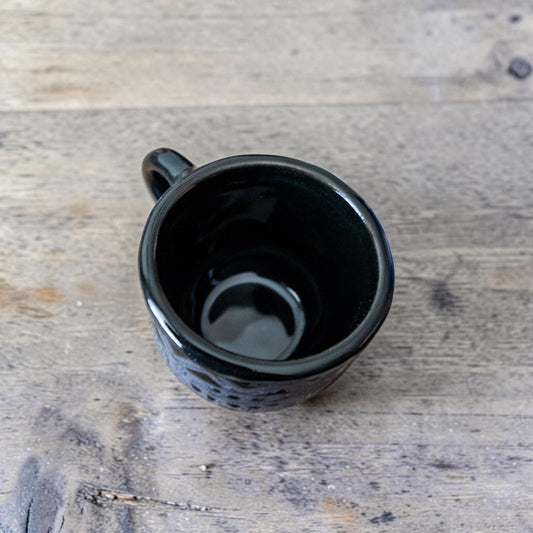 Black stoneware espresso cup with espresso shot