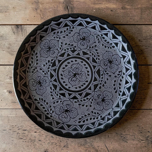 Black stoneware dinner plate floral pattern detail