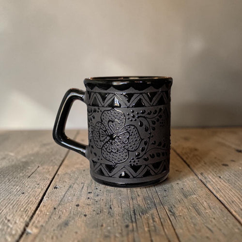 Black handmade mug on kitchen table