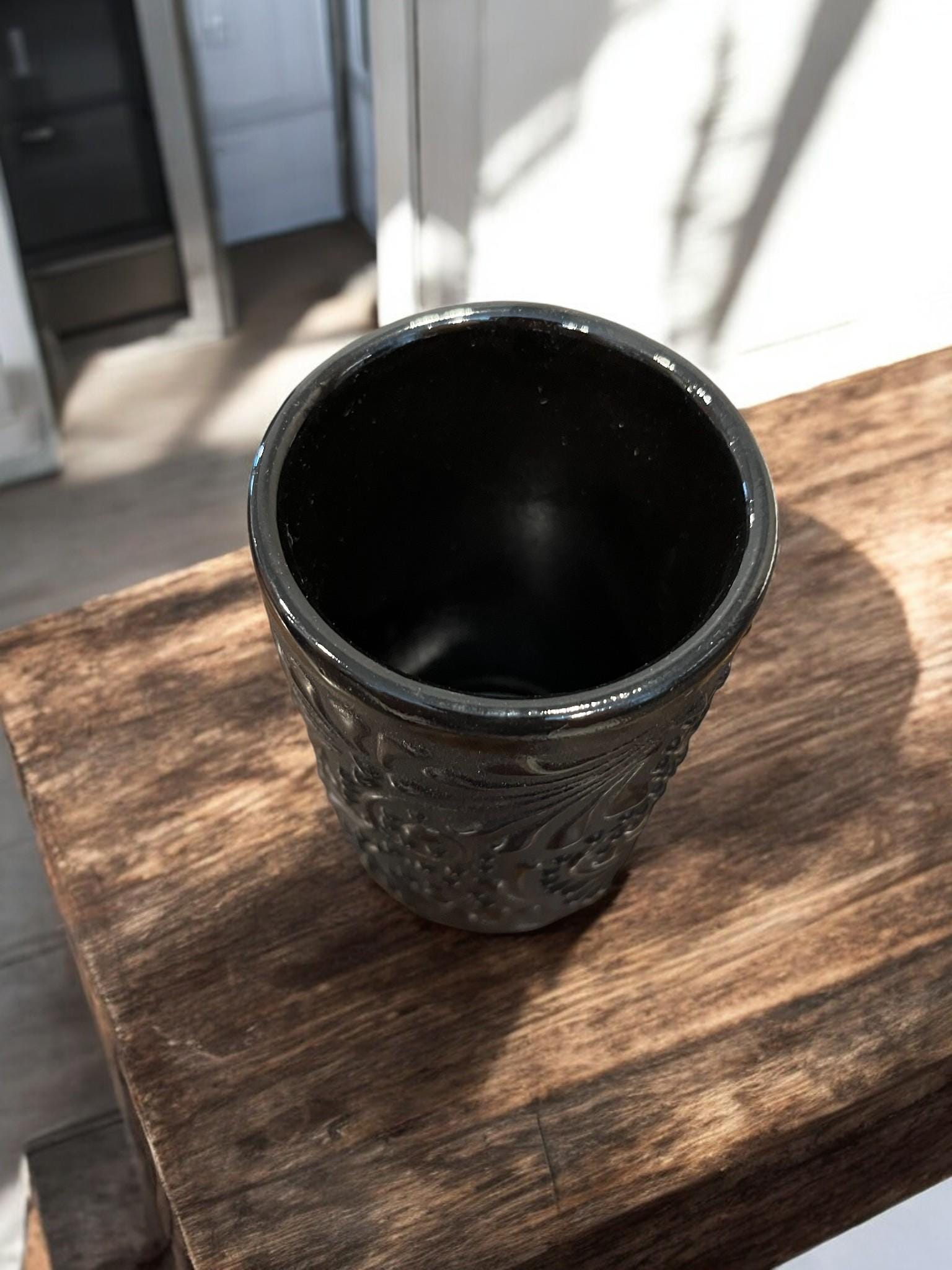 Black Talavera clay cup with matte finish and glossy floral design