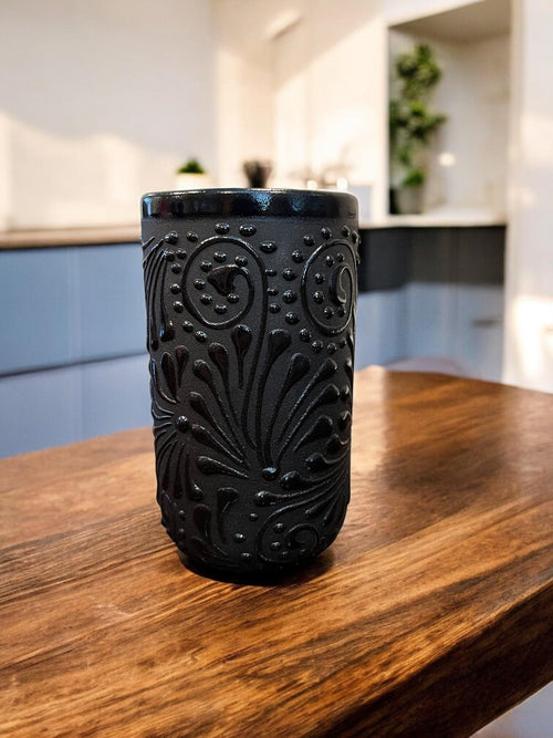 Black Talavera clay cup with traditional Mexican folk-art design