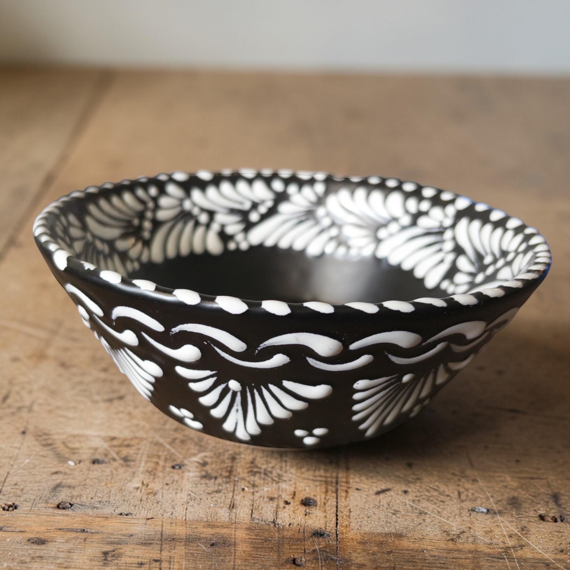 Black Talavera plate with white floral hand-painted pattern