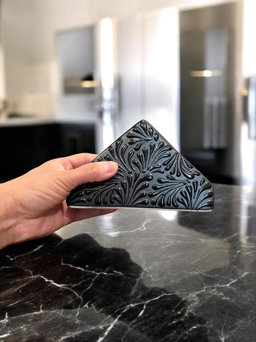 Black Talavera napkin holder with napkins on dining table
