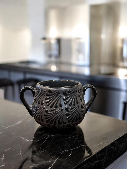Black ceramic sugar bowl on coffee bar - Mexican folk art