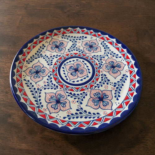 Blue and red stoneware dinner plate hand-painted detail