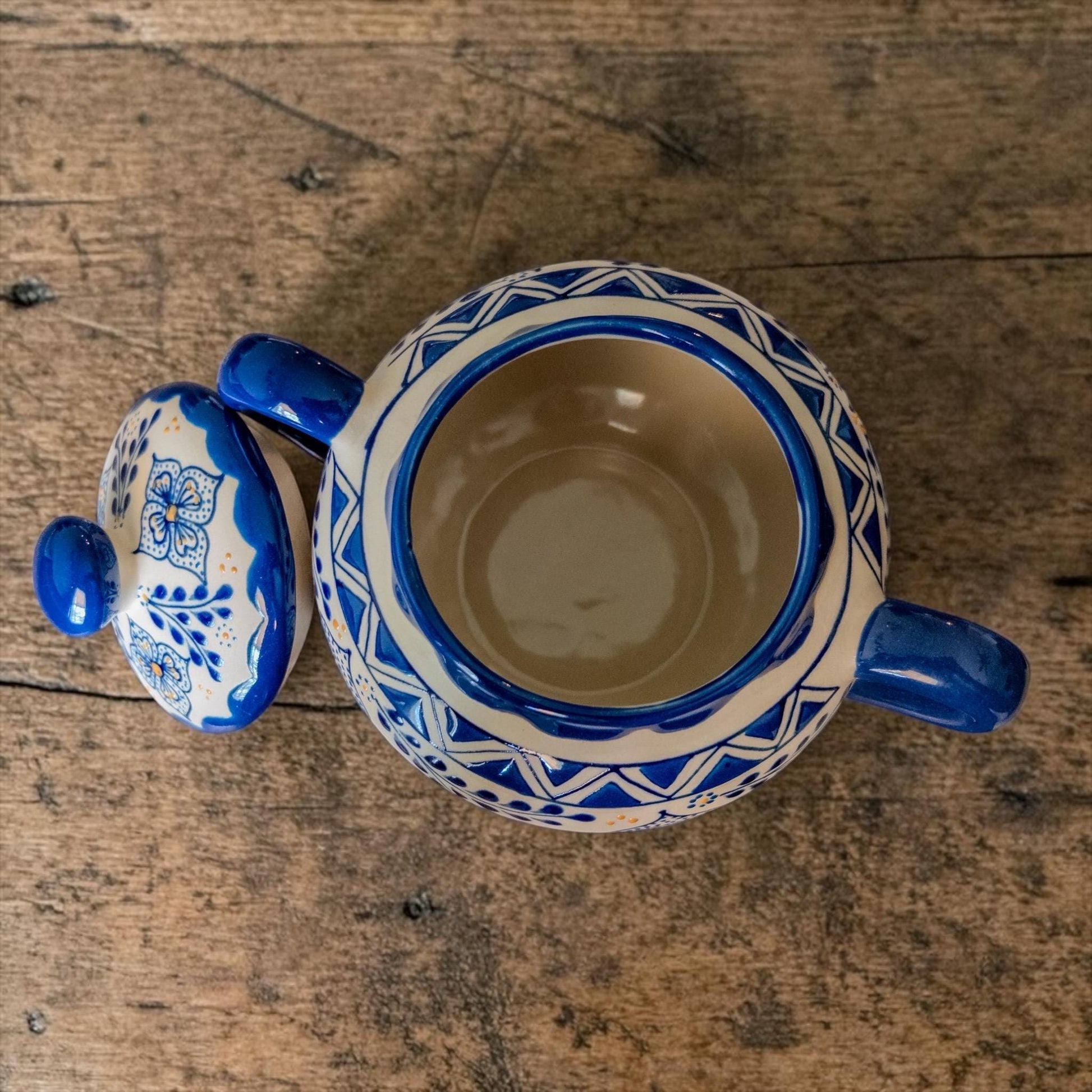 Handmade blue stoneware sugar bowl with floral design and two handles