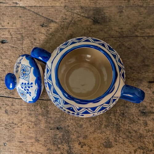 Handmade blue stoneware sugar bowl with floral design and two handles