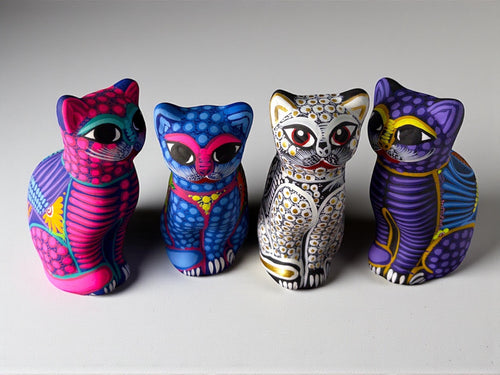 Collection of four colorful clay cat alebrijes, hand-painted Mexican folk art figurines from Guanajuato