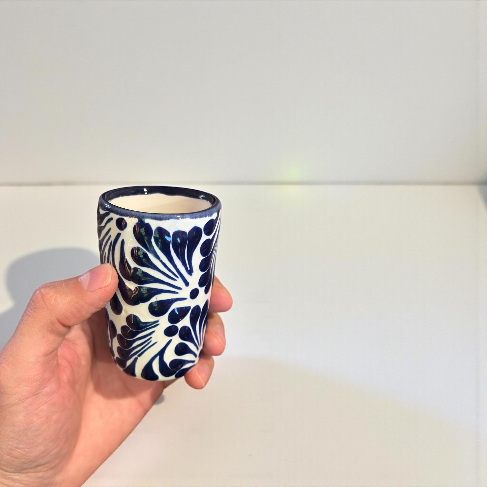 Talavera tequila shot glass set with salt shaker on table, handmade in Puebla Mexico