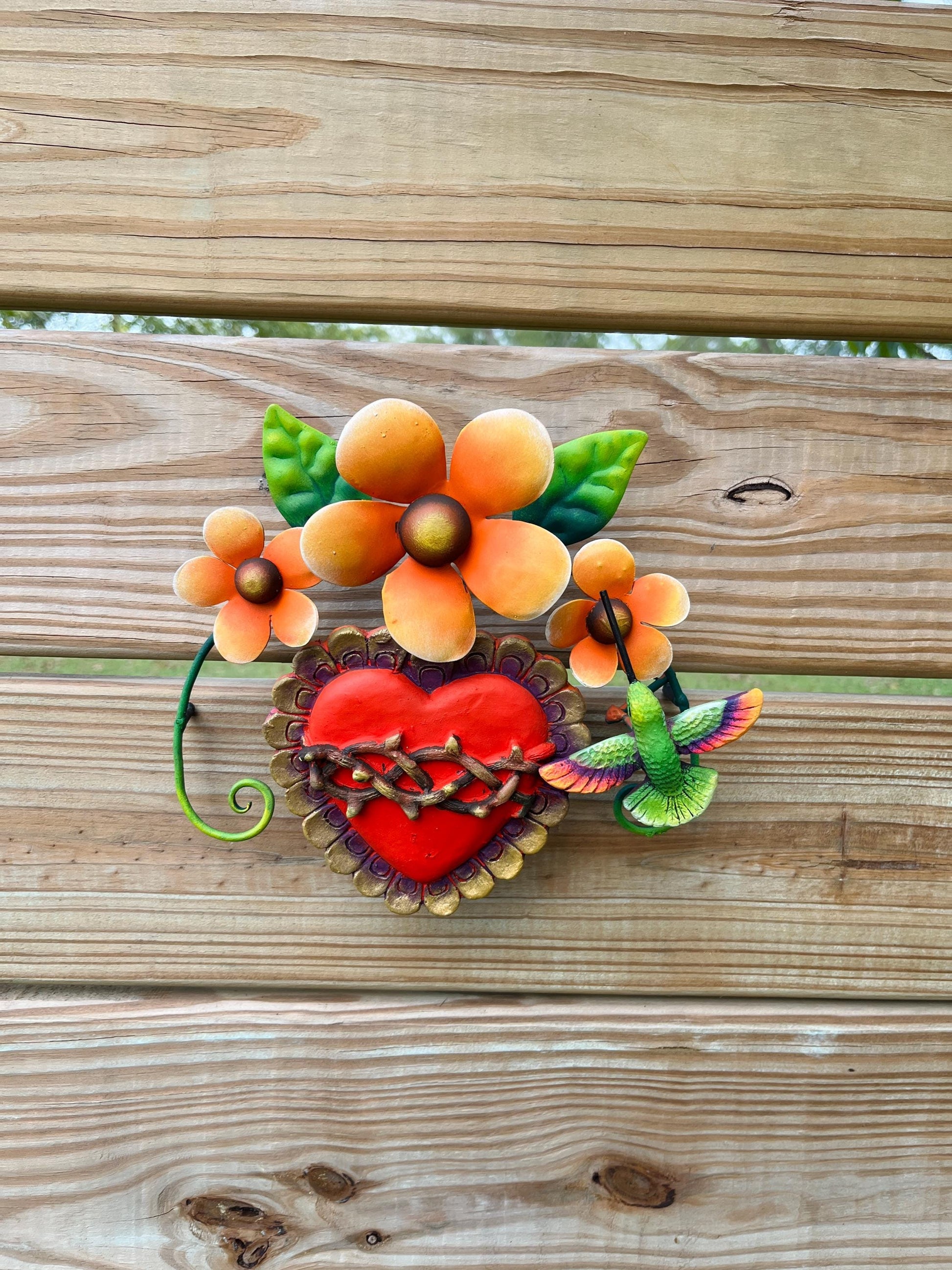 Heart and hummingbird metal wall hanging with orange flowers, artisan made in Mexico