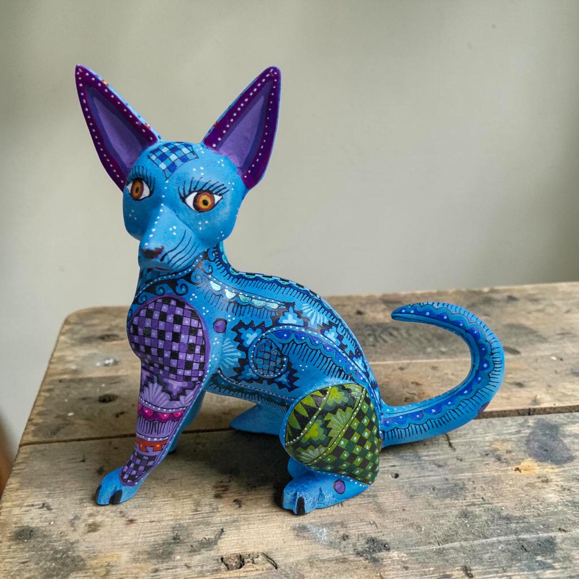 Hand-carved wood dog alebrije from Oaxaca, Mexico, front view