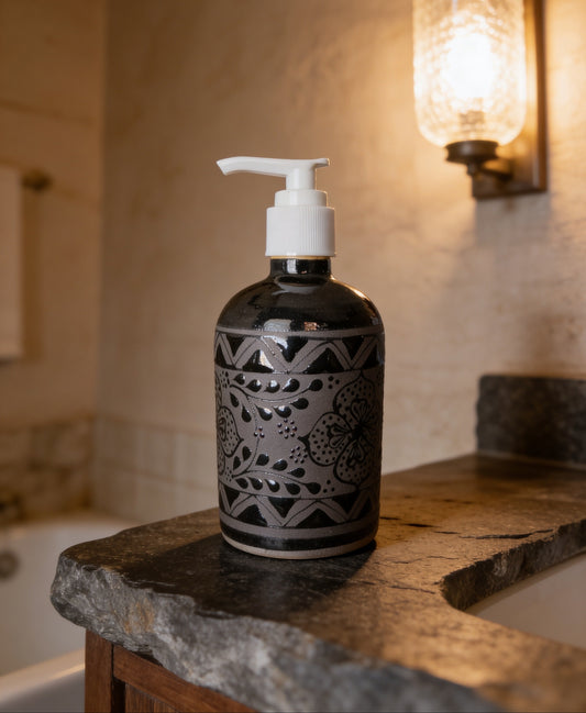Handmade black stoneware ceramic soap dispenser with floral design made in Mexico