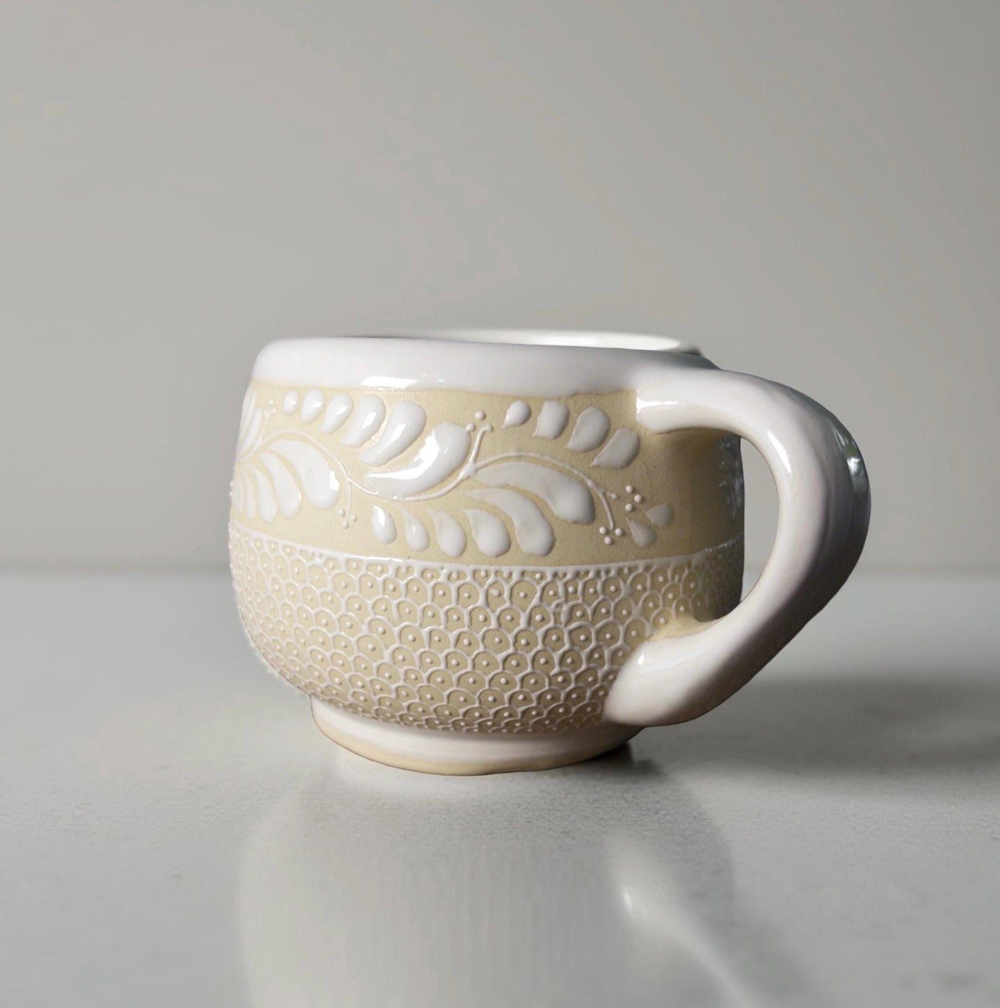 Stoneware floral mug detail of hand-painted pattern, Mexican pottery