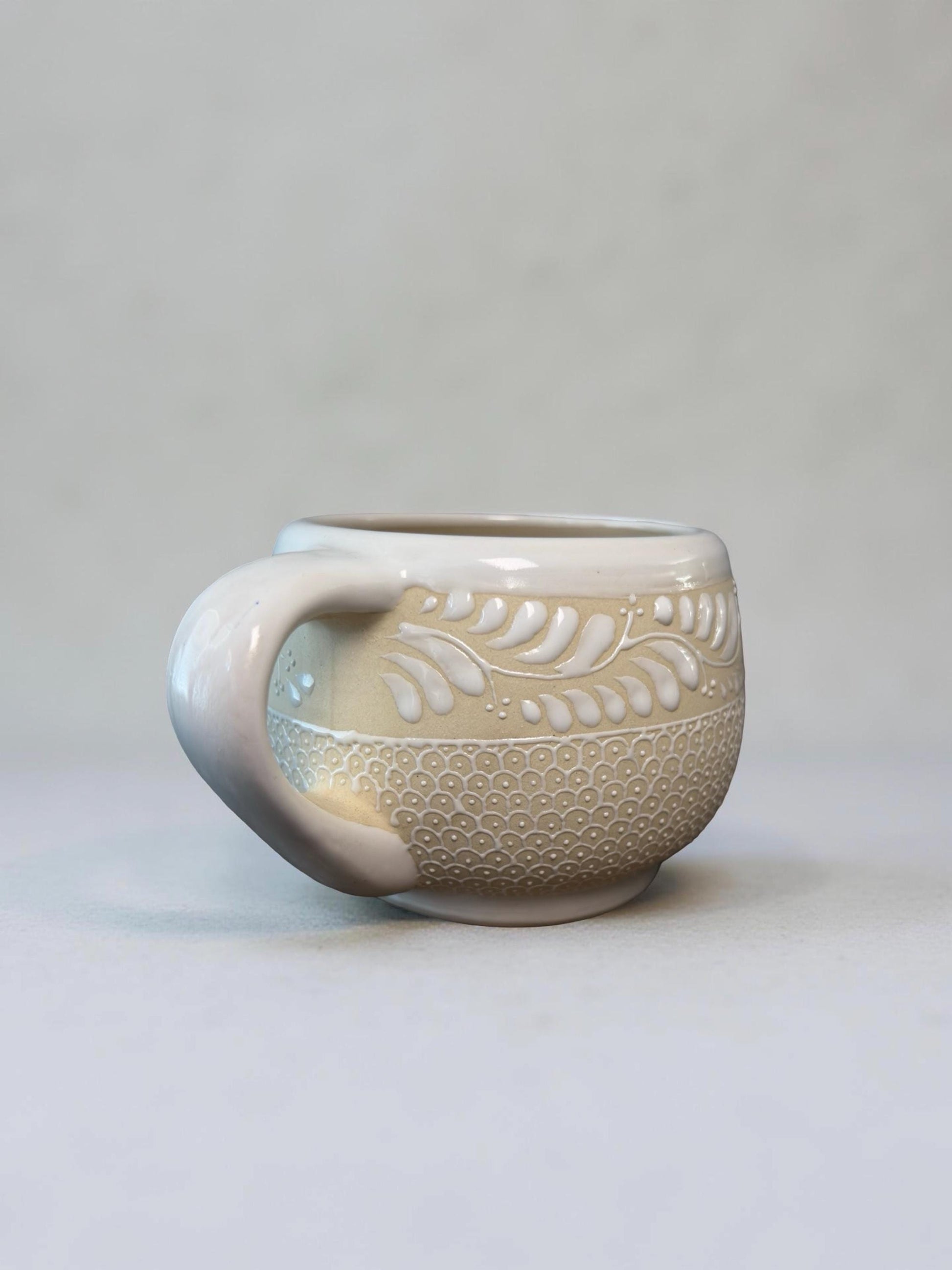 Floral stoneware coffee mug on table, handmade in Mexico