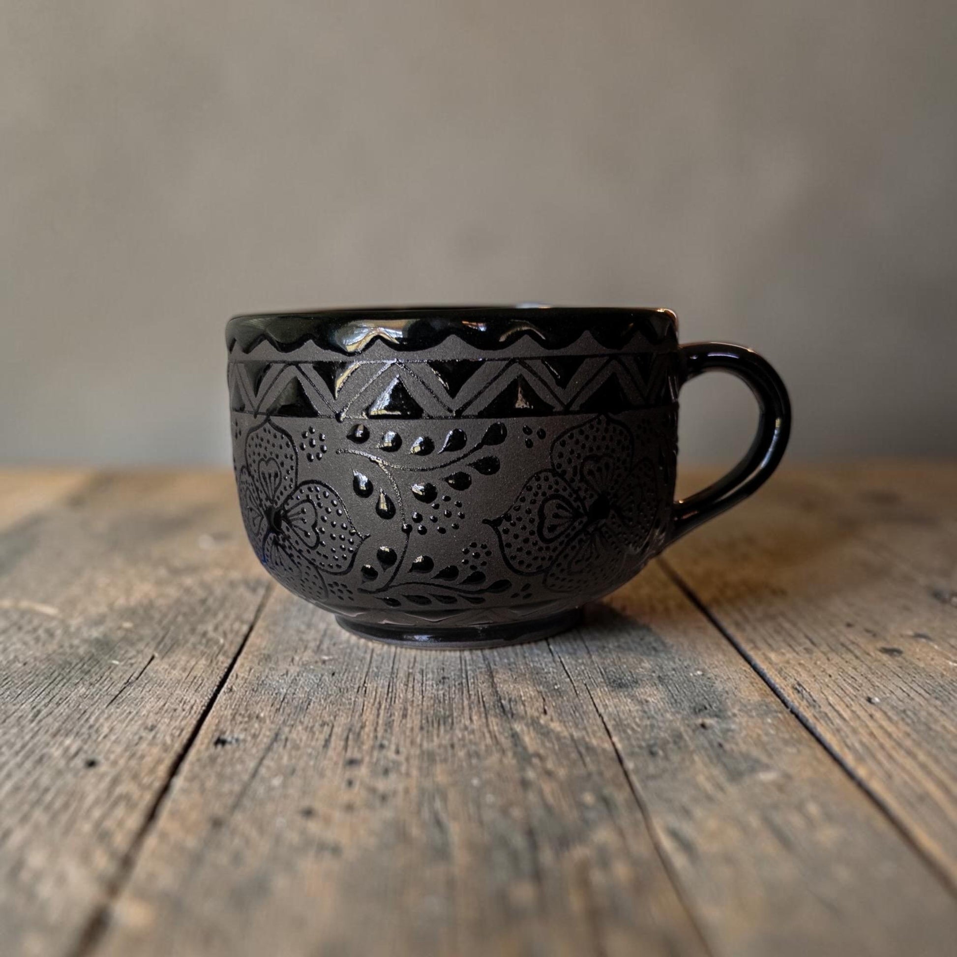 Black stoneware soup mug filled with soup