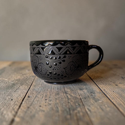 Black stoneware soup mug filled with soup