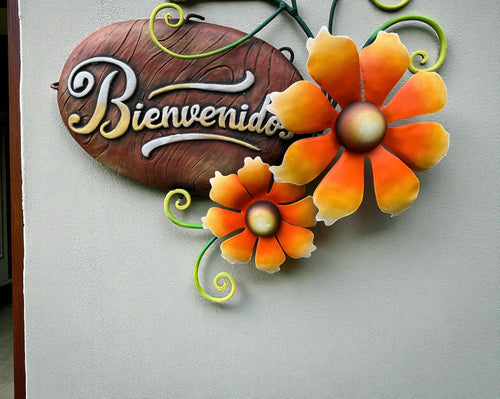Metal Bienvenidos welcome sign hanging on wall, Mexican wall decor