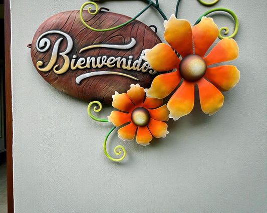 Metal Bienvenidos welcome sign hanging on wall, Mexican wall decor