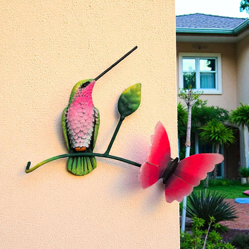 Green and pink metal hummingbird on wall with butterfly, Mexican wall decor