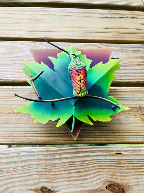 Green metal hummingbird mounted on fence, Mexican outdoor wall decor