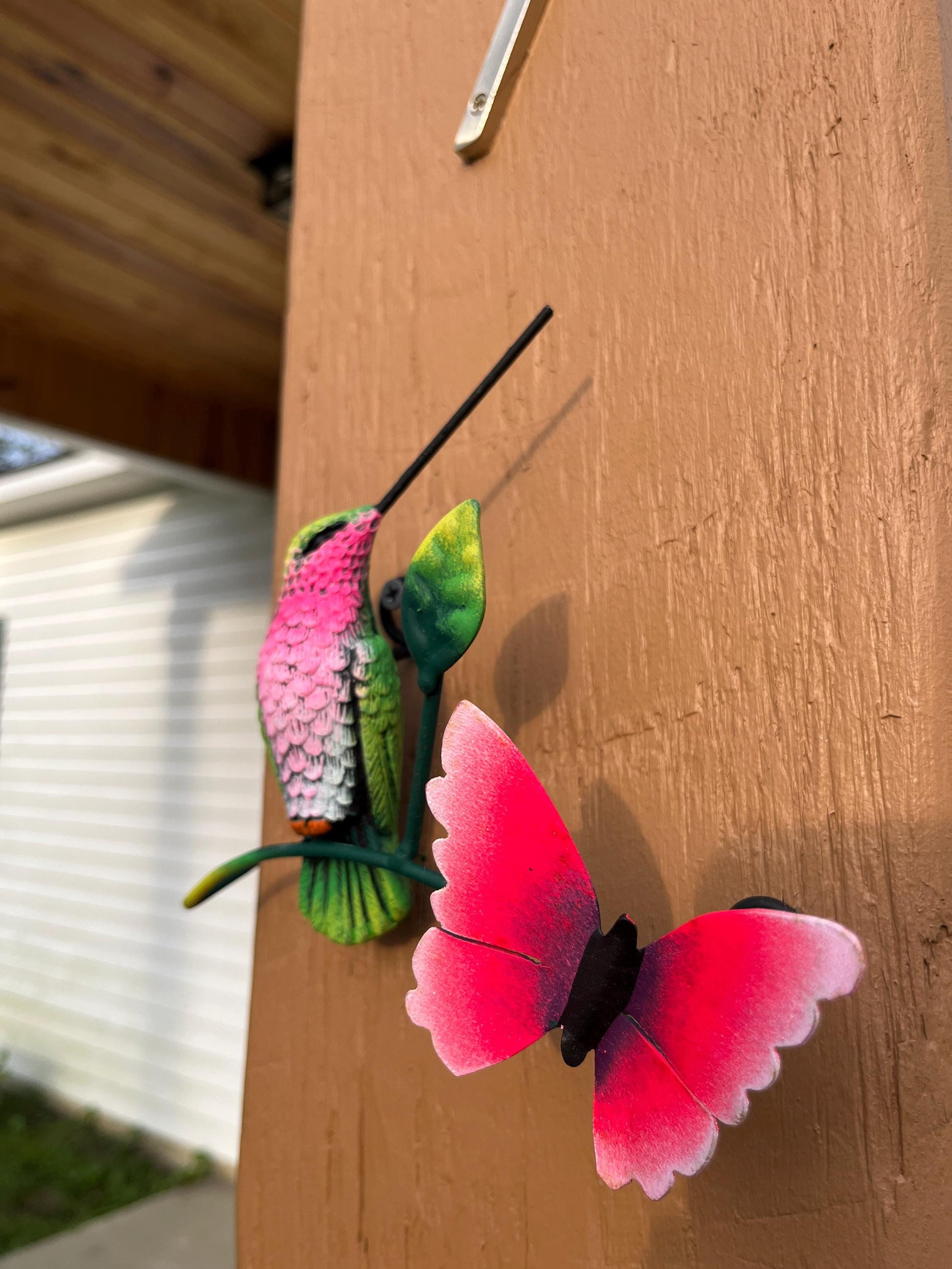 Green and pink metal hummingbird wall decor display, handmade Mexican folk art