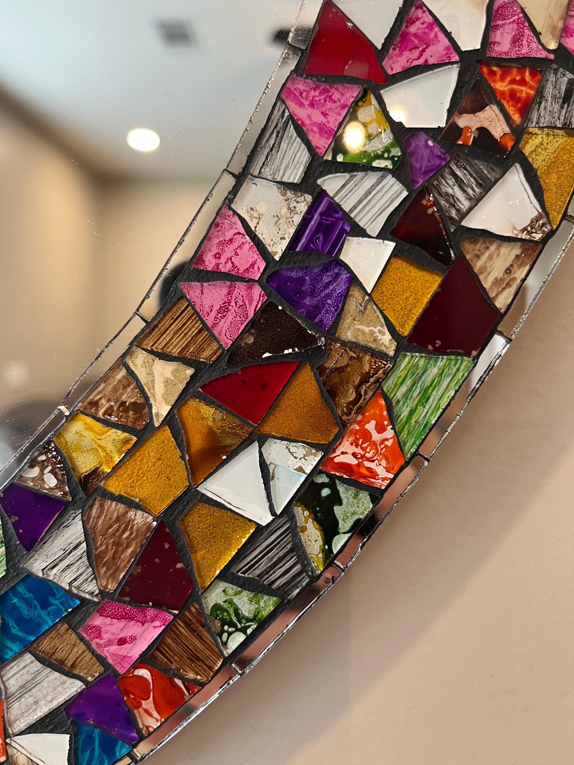 Mosaic mirror frame detail with colorful tiles, handmade Mexican decor