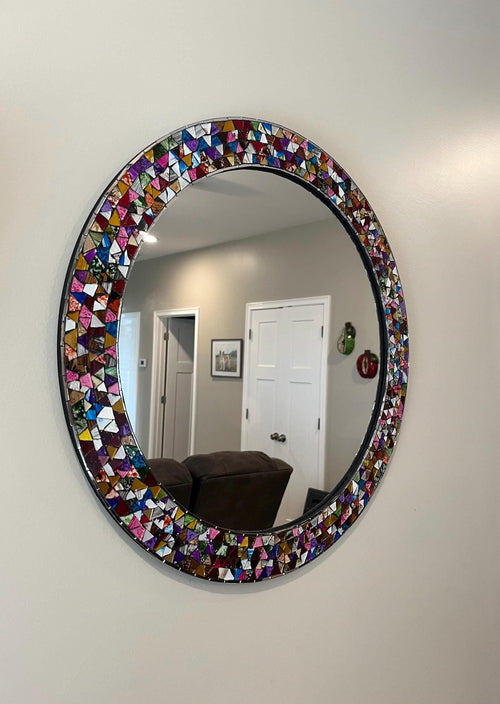 Handmade mosaic mirror on hallway wall, colorful Mexican wall decor