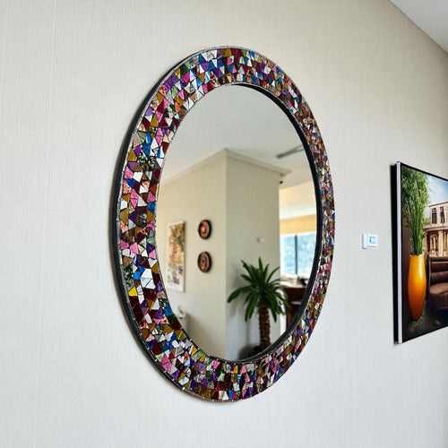 Handmade mosaic mirror hanging on wall with plant, Mexican wall decor