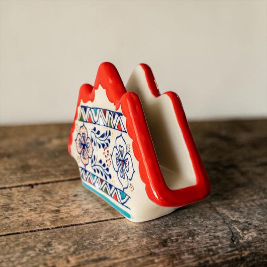 Stoneware napkin holder with napkins on dining table