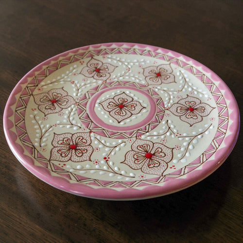 Pink stoneware dinner plate hand-painted detail