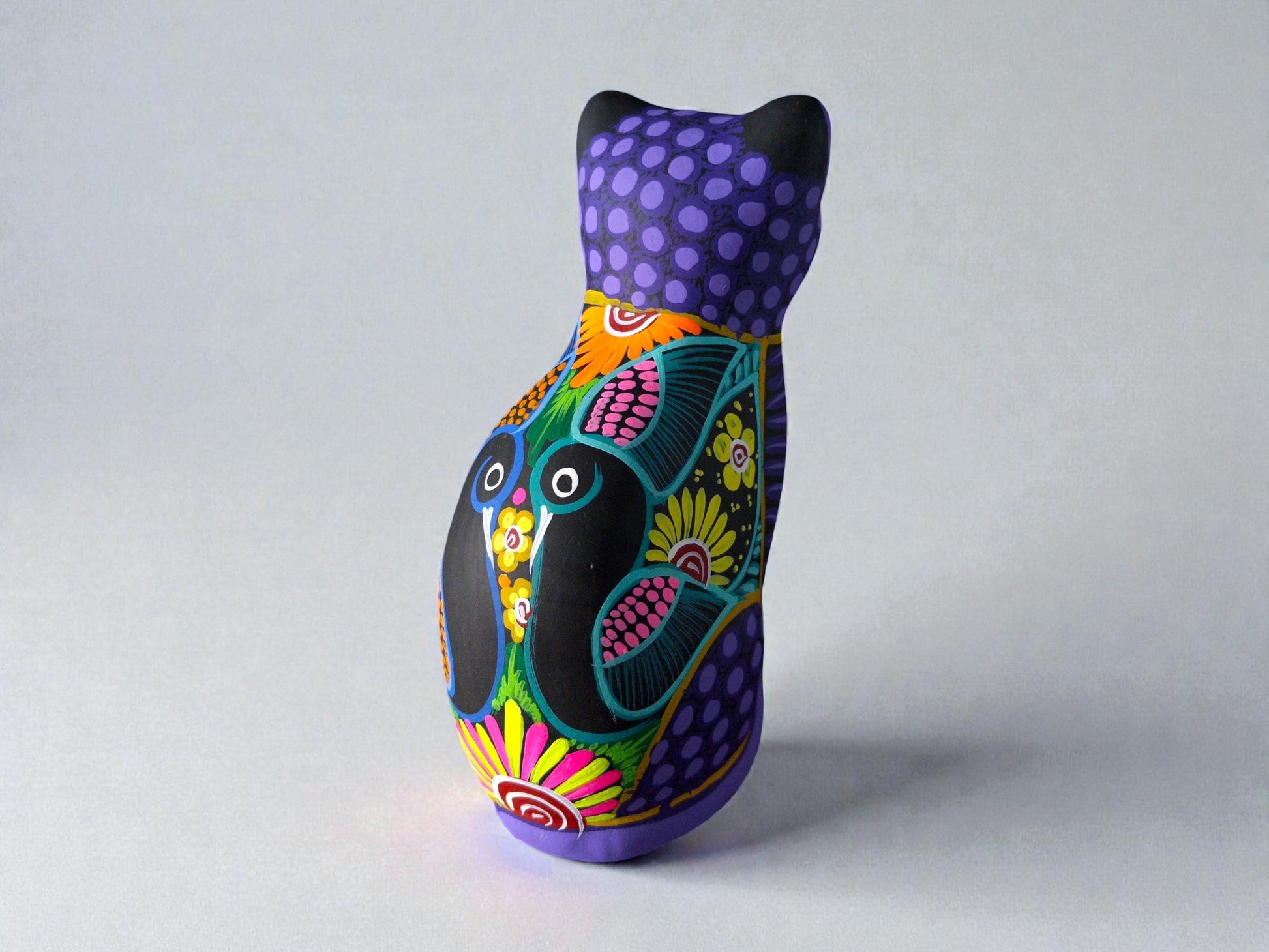 Purple clay cat alebrije with bird and flower design, handmade Mexican folk art figurine