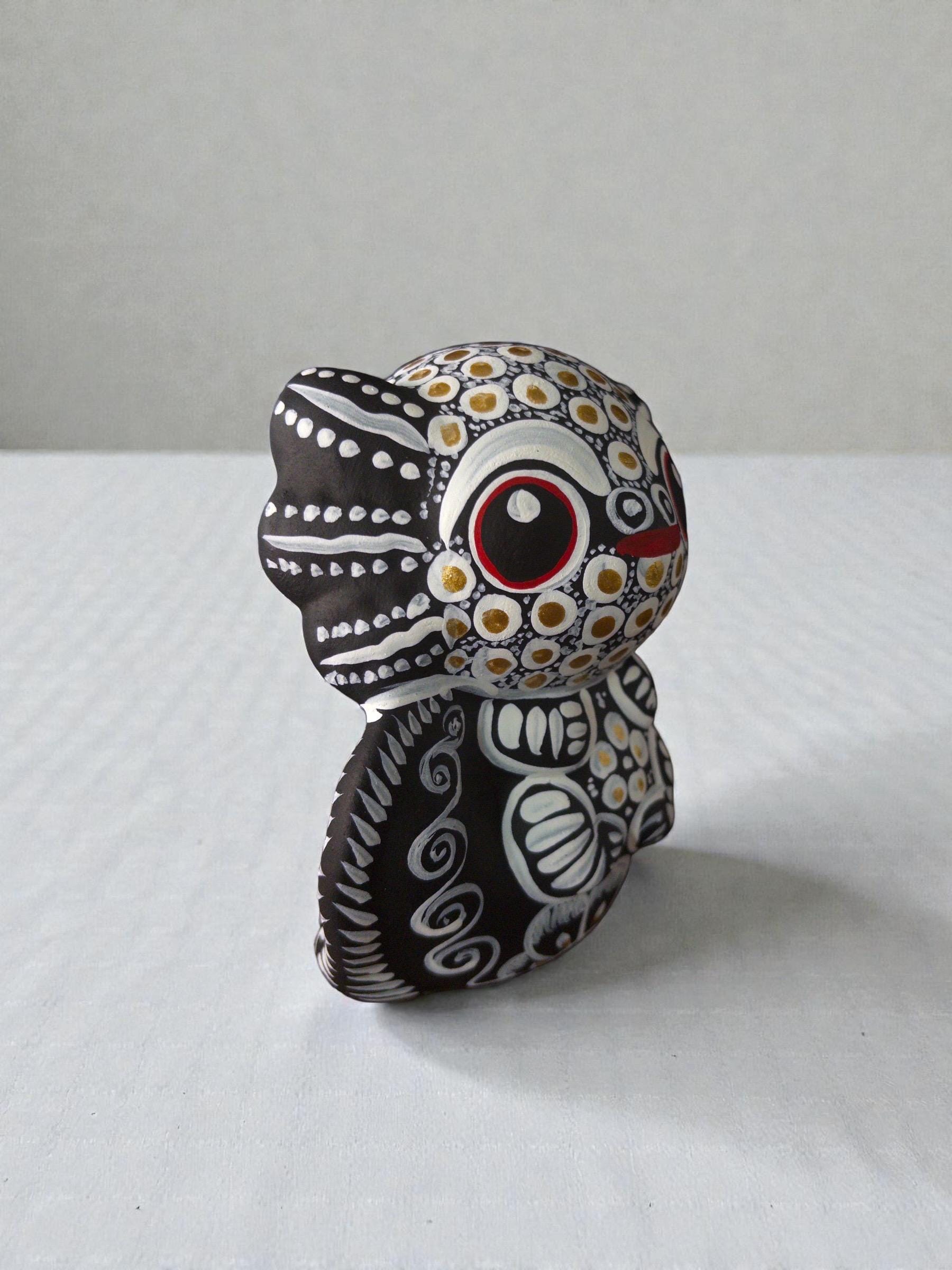 white axolotl alebrije side view, handpainted clay Mexican folk art