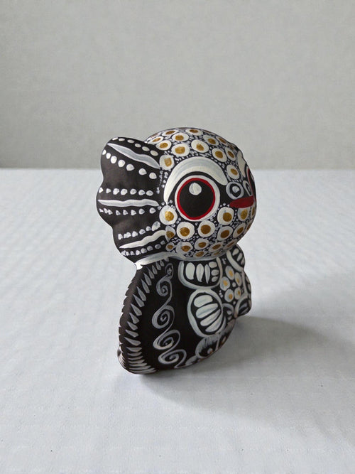 white axolotl alebrije side view, handpainted clay Mexican folk art