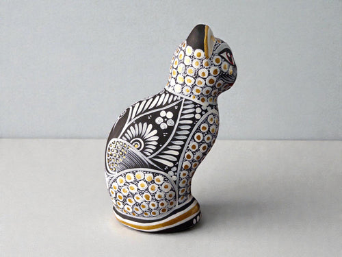 White and black spotted clay cat alebrije, hand-painted Mexican folk art figurine from Guanajuato